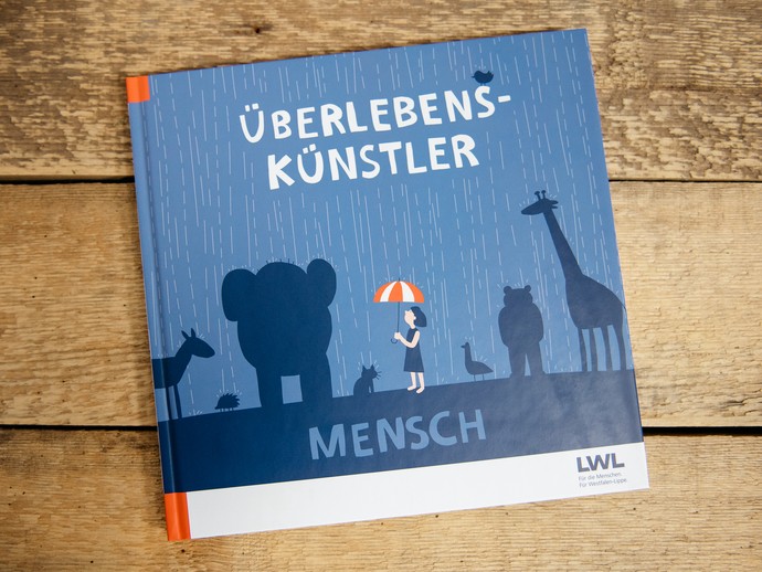 Buchcover vom Begeleitbuch zur Sonderausstellung Überlebnskünstler Mensch. (vergrößerte Bildansicht wird geöffnet)