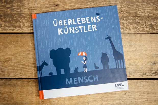 Buchcover vom Begleitbuch zur Sonderausstellung "Überlebenskünstler Mensch".